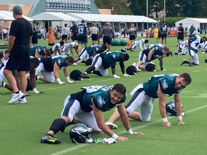 Devon Allen (left) and Britain Covey go through pre-practice stretches